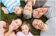 Large family smiling after dental services