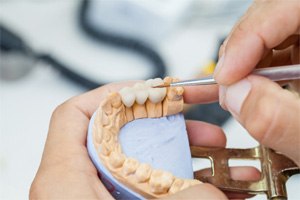 Lab artisan making dental bridge in Shorewood