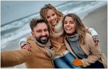 Large family smiling after dental services