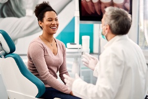 A woman listening to her dentist in preparation for using her dental insurance in Shorewood