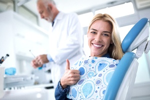 A woman giving a thumbs up while visiting her dentist in Shorewood
