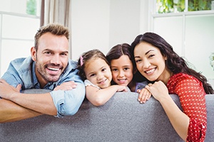 Parents and their young children smiling