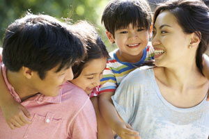 Mother father and two kids smiling after general dentistry