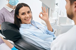 Dental patient using hand to make OK sign