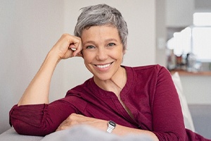 Mature, smiling woman enjoying her implant dentures in Shorewood