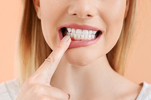 a dental patient pointing to her gums
