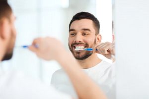 man brushing his teeth