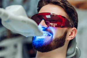 Man smiling during in-office teeth whitening in Shorewood