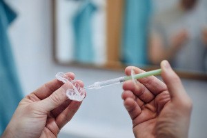 Man smiling during in-office teeth whitening in Shorewood