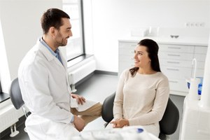 Woman smiling at cosmetic dentist in Shorewood