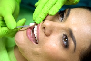 Woman having veneers placed by cosmetic dentist in Shorewood