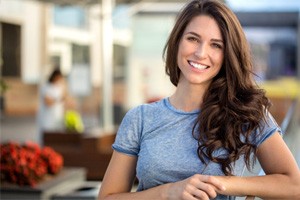 Woman outside in front yard smiling after teeth whitening in Shorewood, 