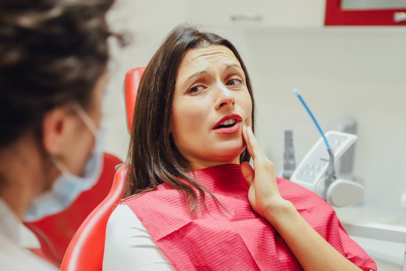 Woman with a toothache speaking to her dentist
