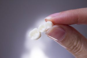 hand holding a dental bridge