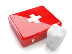 Large model tooth next to a red emergency kit