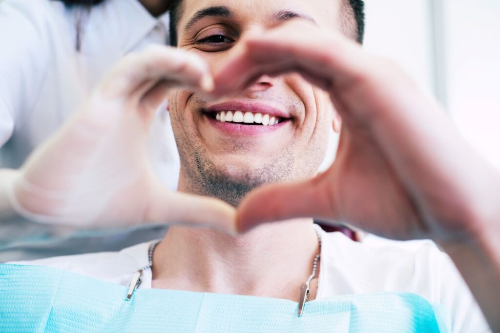 A man smiling in a dental chair