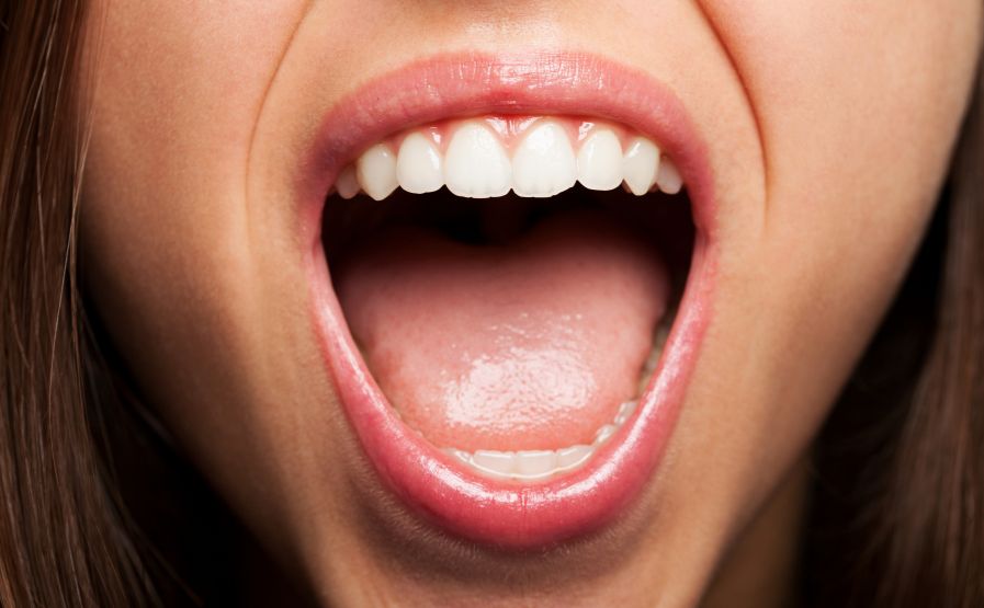 A closeup of a woman&rsquo;s open mouth