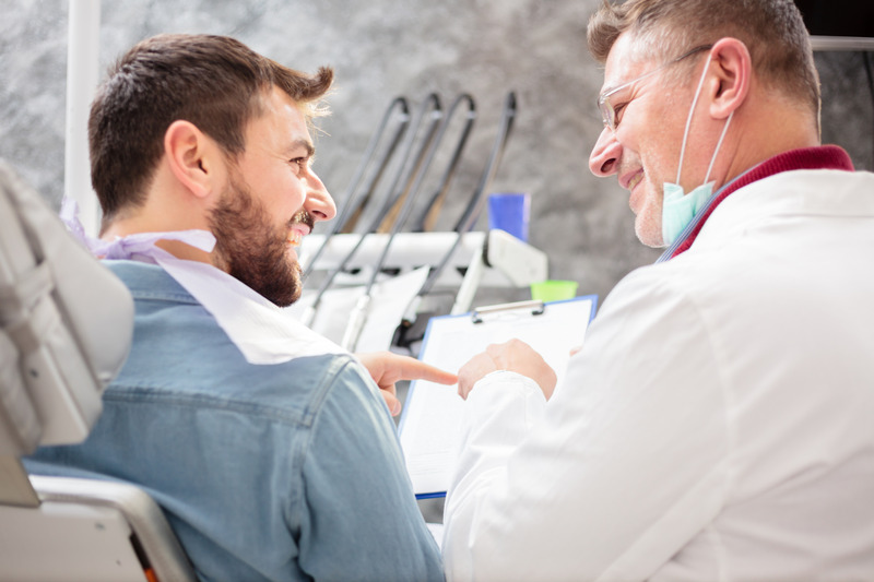 Patient with good oral health smiling at dentist